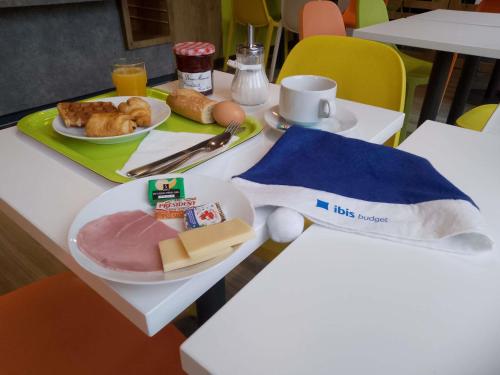 a table with a plate of food on top of it at Ibis Budget Limoges Nord in Limoges