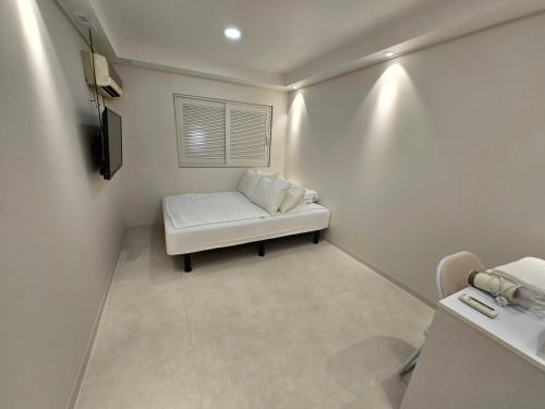 a small room with a white couch and a window at Han River KS Stay in Seoul