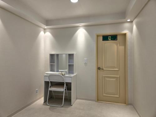 a hallway with a door and a desk with a mirror at Han River KS Stay in Seoul