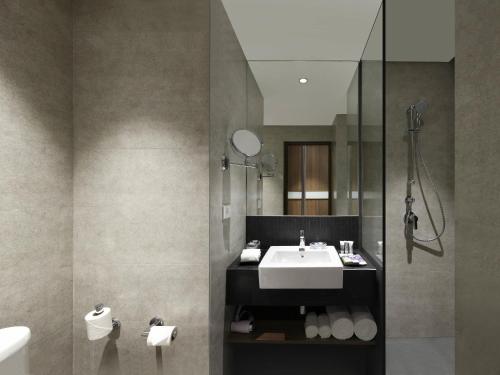 a bathroom with a sink and a shower at Mercure Chennai Sriperumbudur in Sriperumbudur