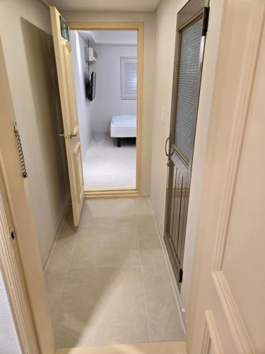 a hallway with a door leading to a bedroom at Han River KS Stay in Seoul