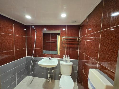 a bathroom with a toilet and a sink and a mirror at Han River KS Stay in Seoul