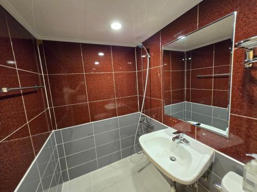 a bathroom with a sink and a mirror at Han River KS Stay in Seoul