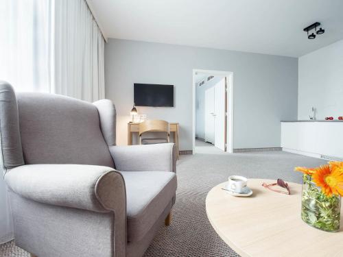 a living room with a couch and a coffee table at ibis Styles Siedlce in Siedlce