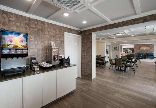 an office with a reception area with a tv on a wall at SureStay Plus by Best Western Pigeon Forge in Pigeon Forge