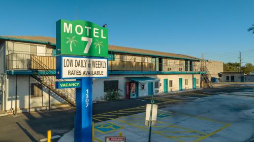 a motel sign in front of a parking lot at Motel 7 By OYO Near Phoenix Airport in Mesa