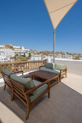 a patio with two chairs and a table on a balcony at Argo Hotel in Platis Yialos Mykonos