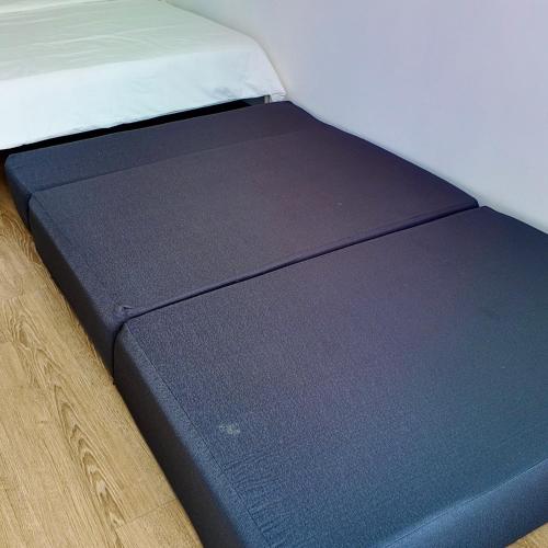 a close up of a bed with a blue mattress at dChamp Retreat in Changlun