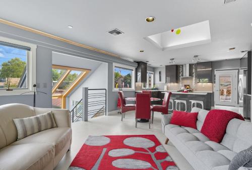 a living room with two couches and a kitchen at Modern Upper Level Duplex DT Vancouver in Vancouver