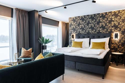 a bedroom with a large bed and a couch at Scandic Hell in Hell