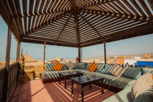 a living room with a couch and a table at Surfer's Heimat Hostel in Tamraght Ouzdar