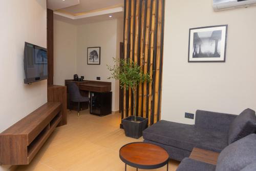 a living room with a couch and a table at Grayville Hotels and Bistro in Akure