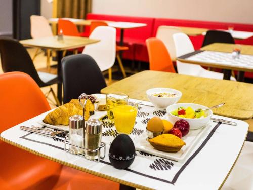 a tray of food on a table with fruit and juice at ibis Bordeaux Centre Gare Saint Jean Euratlantique in Bordeaux