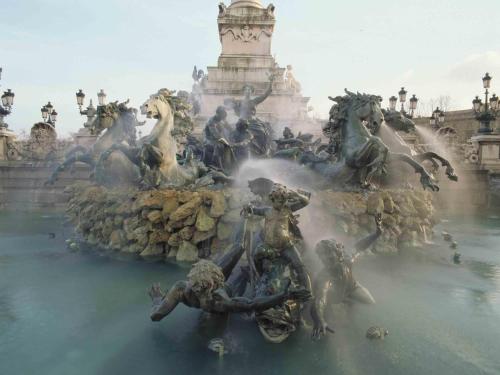 a fountain with a group of statues in the water at ibis Bordeaux Centre Gare Saint Jean Euratlantique in Bordeaux