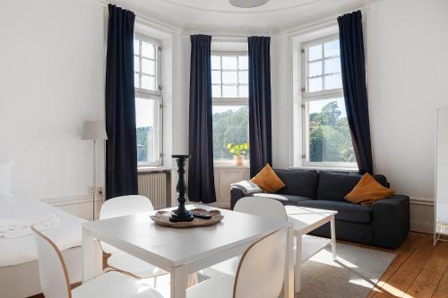 a living room with a white table and a couch at Stay Inn Apartments in Vasastan in Stockholm