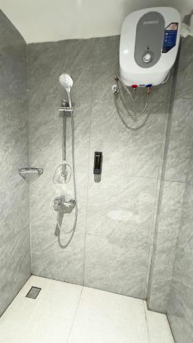 a shower with a shower head and a shower at Yado Living in Karanganyar