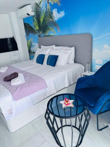 a bedroom with a bed and a table and a chair at Blue Ocean Costa Adeje 504 in Playa de las Americas