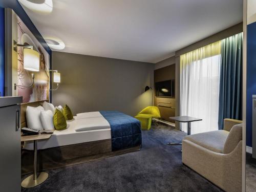Ένα ή περισσότερα κρεβάτια σε δωμάτιο στο MERCURE Hotel Berlin Wittenbergplatz