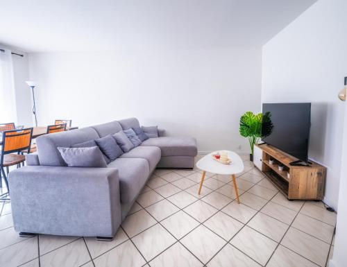 a living room with a couch and a table at T3 68m2 Garage Terrasse Gare aux portes de Genève in Saint-Julien-en-Genevois