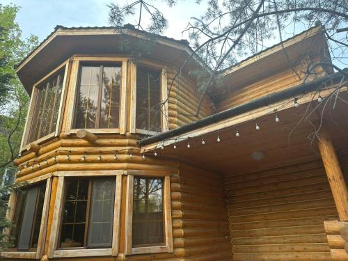 a wooden house with windows on top of it at Дом СКАЗКА in Astana