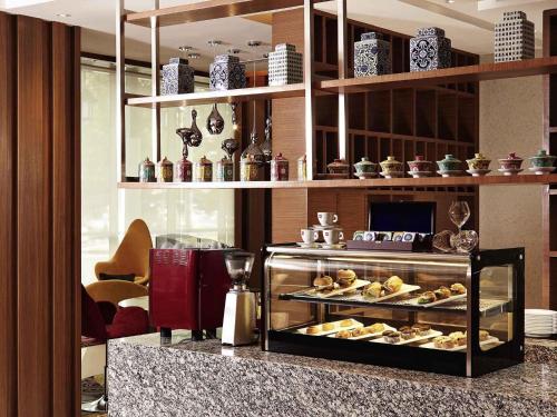 a bakery with a display case filled with pastries at Mercure Kuala Lumpur Shaw Parade in Kuala Lumpur
