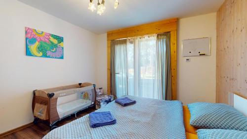 a small bedroom with a bed and a window at Dům v srdci Beskyd - Morávka - 6 pokojů in Morávka