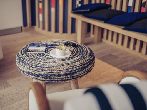 a table with a cup of coffee on top of it at Hotel Mercure Brest Centre Les Voyageurs in Brest