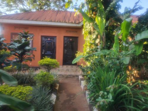 a house in the middle of a garden at Gorilla African Guest House in Entebbe