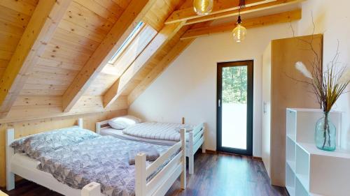 a bedroom with two beds in a attic at Dům v srdci Beskyd - Morávka - 6 pokojů in Morávka
