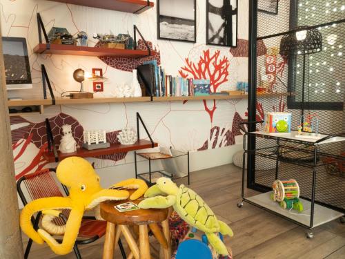 a room with a chair and a table with toys at ibis Styles Barcelona City Bogatell in Barcelona