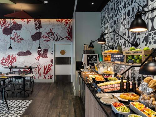 a bakery with a counter with food on it at ibis Styles Barcelona City Bogatell in Barcelona