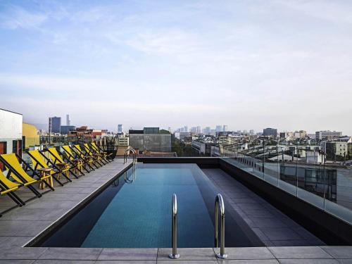 a swimming pool on the roof of a building at ibis Styles Barcelona City Bogatell in Barcelona