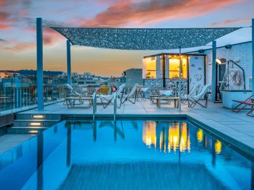 a swimming pool on the roof of a building at ibis Styles Barcelona City Bogatell in Barcelona