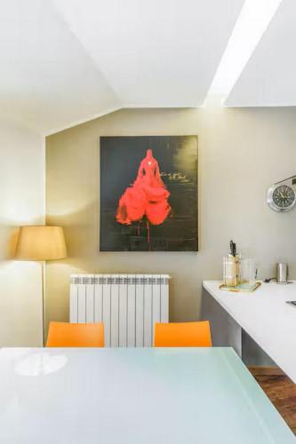 a kitchen with a white table and orange chairs at Villetta Ginori - Private Spa in Grosseto