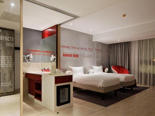 a hotel room with a bed and a fireplace at ibis Styles Batam Nagoya in Nagoya