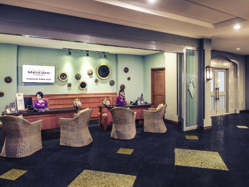 a lobby with two women sitting at a waiting room at Mercure Yangon Kaba Aye in Yangon