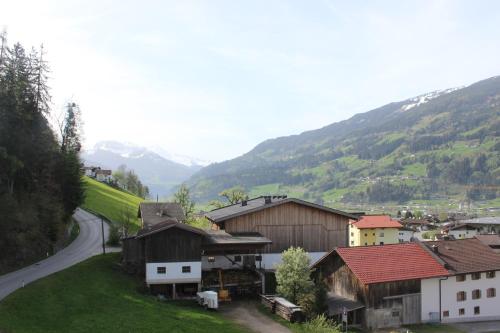 a village with a road and mountains in the background at Hotel - Gasthof Märzenklamm in Stumm