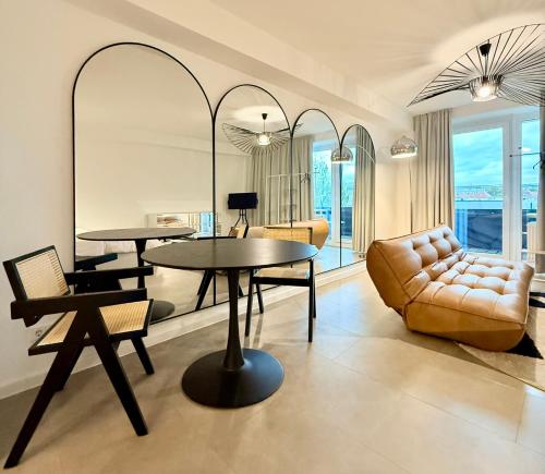 a living room with two tables and a couch at STUDIO No 3 in Bad Kreuznach