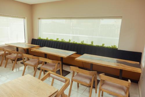 a row of tables and chairs in a restaurant at Grayville Hotels and Bistro in Akure