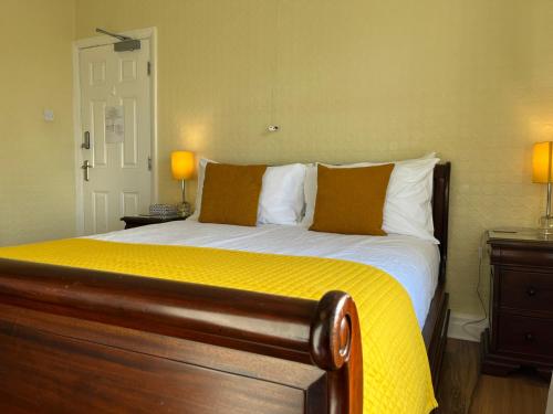 a bedroom with a bed with a yellow comforter at 1 Lathom Ave - Parking, 2 Bathrooms, Comfortable, Welcoming, Nice Area in Morecambe