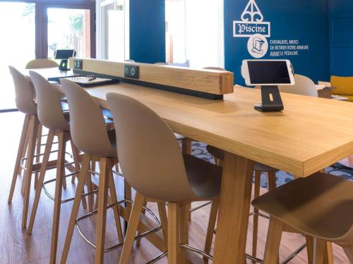 a conference room with a wooden table and chairs at ibis Styles Carcassonne La Cité in Carcassonne