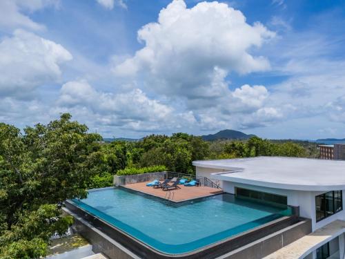 an aerial view of a house with a swimming pool at 九雅集 The Nine Refined Retreats in Rawai Beach