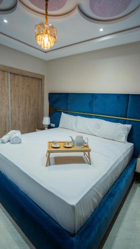 a bedroom with a large bed with a table on it at Appart Hôtel Golden Sky Home Café Restaurant & Spa in Beni Mellal