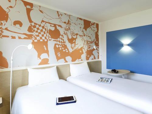 Ένα ή περισσότερα κρεβάτια σε δωμάτιο στο ibis Styles Toulouse Nord Sesquieres