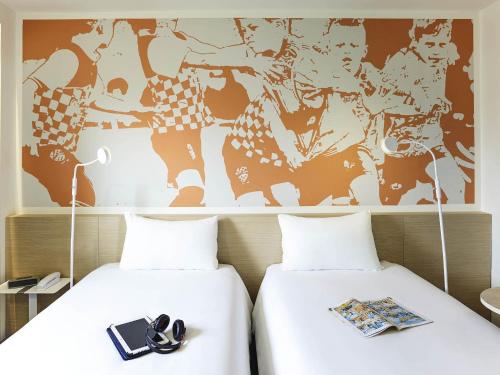 Ένα ή περισσότερα κρεβάτια σε δωμάτιο στο ibis Styles Toulouse Nord Sesquieres