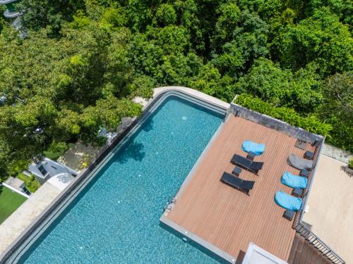 an overhead view of a swimming pool with two lounge chairs at 九雅集 The Nine Refined Retreats in Rawai Beach