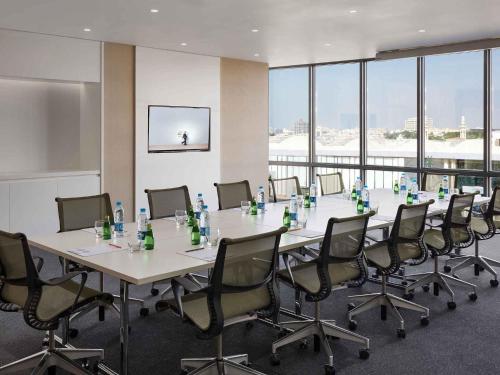 a large conference room with a long table and chairs at Novotel Jeddah Tahlia in Jeddah