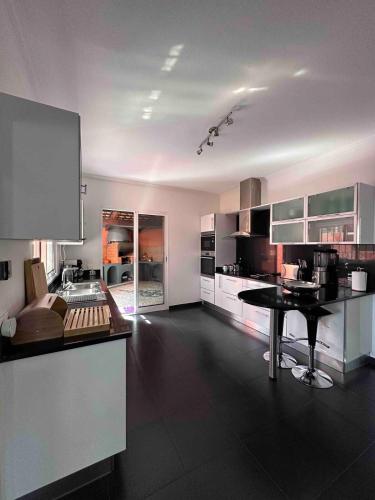 a large kitchen with a table in the middle at VILLA Valhalla Private heated swimming-pool in Funchal