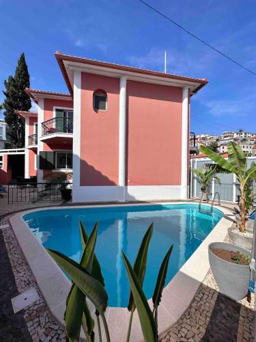 a swimming pool in front of a house at VILLA Valhalla Private heated swimming-pool in Funchal