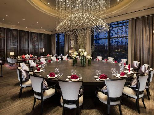 a large dining room with a large table and chairs at Pullman Hefei Sunac in Hefei